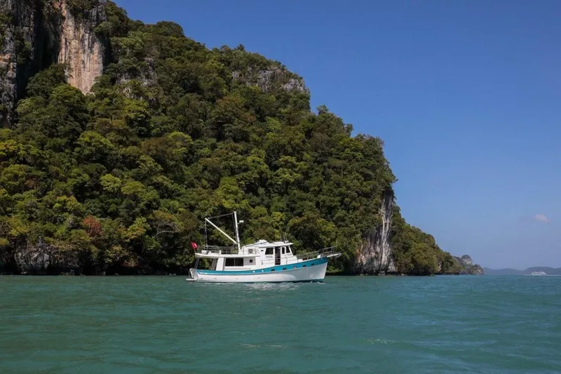 My Lindavia Yacht Photos Pics Kadey-Krogen 44 boat cruising near lush island cliffs, 2012 model.