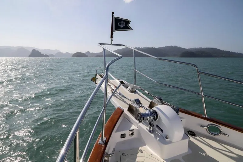 My Lindavia Yacht Photos Pics Bow of 2012 Kadey-Krogen 44 yacht cruising on serene waters with distant islands.