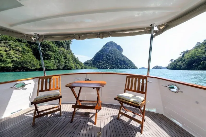 My Lindavia Yacht Photos Pics Deck view from 2012 Kadey-Krogen 44 yacht, featuring chairs and table, overlooking scenic islands.