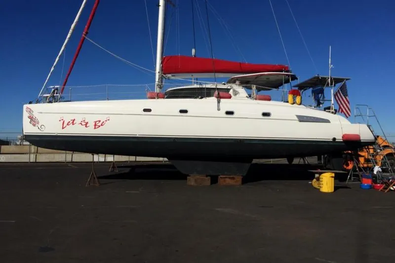 Let It Be Yacht Photos Pics 2003 Fountaine Pajot Bahia catamaran on land with red sail and American flag.