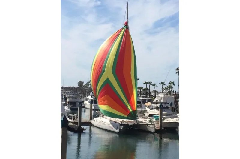 Let It Be Yacht Photos Pics 2003 Fountaine Pajot Bahia catamaran with colorful sail in marina.