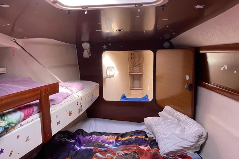 Let It Be Yacht Photos Pics 2003 Fountaine Pajot Bahia cabin interior with cozy bedding and star-themed decor.