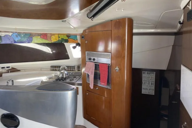 Let It Be Yacht Photos Pics Interior of 2003 Fountaine Pajot Bahia yacht with modern kitchen and colorful decor.