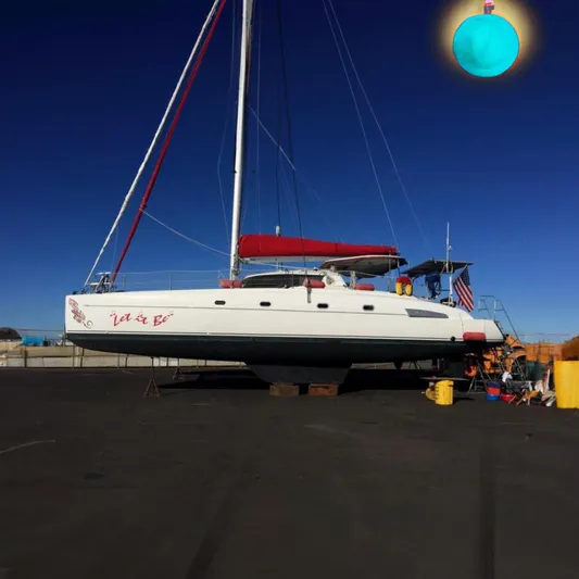 Let It Be Yacht Photos Pics 2003 Fountaine Pajot Bahia catamaran on land, with red sail cover and American flag.
