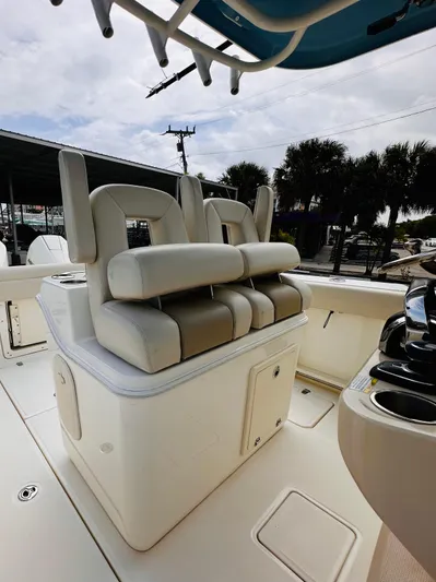 Priced To Sell! Yacht Photos Pics 2020 Boston Whaler 280 Outrage boat seating area with cushioned seats and storage.