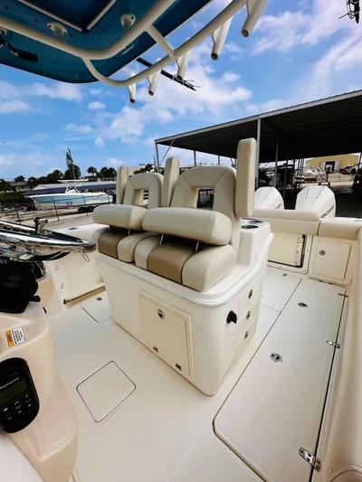 Priced To Sell! Yacht Photos Pics 2020 Boston Whaler 280 Outrage boat interior with cushioned seating and storage compartments.