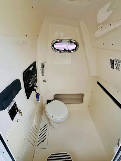 Priced To Sell! Yacht Photos Pics Interior of 2020 Boston Whaler 280 Outrage boat, featuring a compact marine toilet.