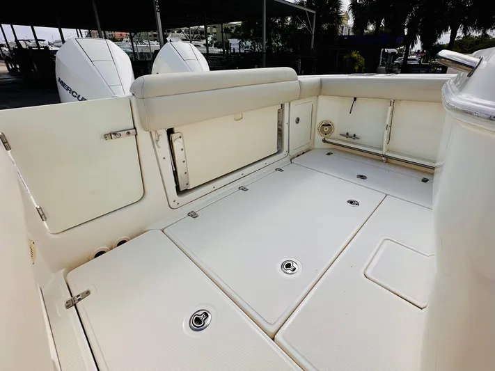 Priced To Sell! Yacht Photos Pics 2020 Boston Whaler 280 Outrage boat deck with storage compartments and seating.