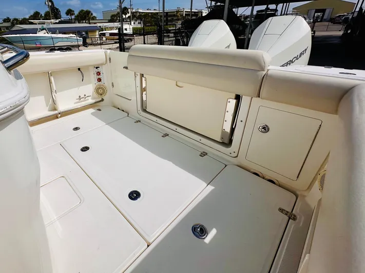 Priced To Sell! Yacht Photos Pics 2020 Boston Whaler 280 Outrage boat deck with storage compartments and twin Mercury engines.