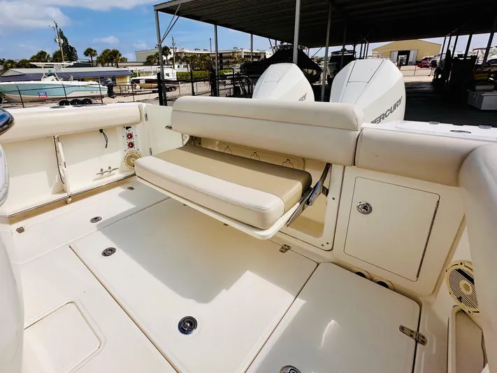 Priced To Sell! Yacht Photos Pics 2020 Boston Whaler 280 Outrage boat interior with foldable seating and storage compartments.
