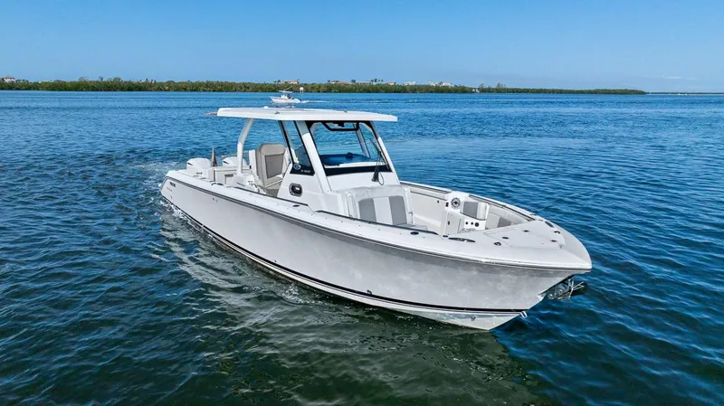  Yacht Photos Pics 2021 Pursuit S 328 Sport boat cruising on clear blue water.