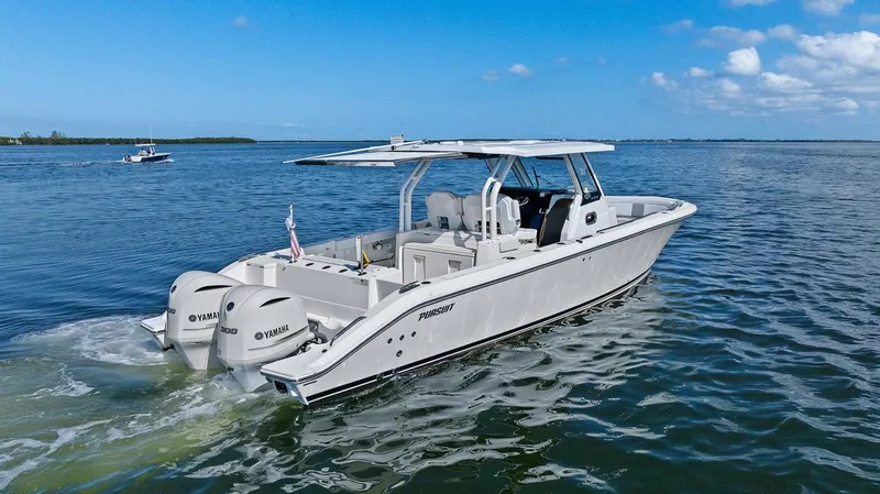  Yacht Photos Pics 2021 Pursuit S 328 Sport boat cruising on open water under clear skies.
