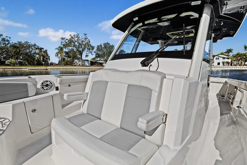  Yacht Photos Pics 2021 Pursuit S 328 Sport boat interior with cushioned seating and sleek design.