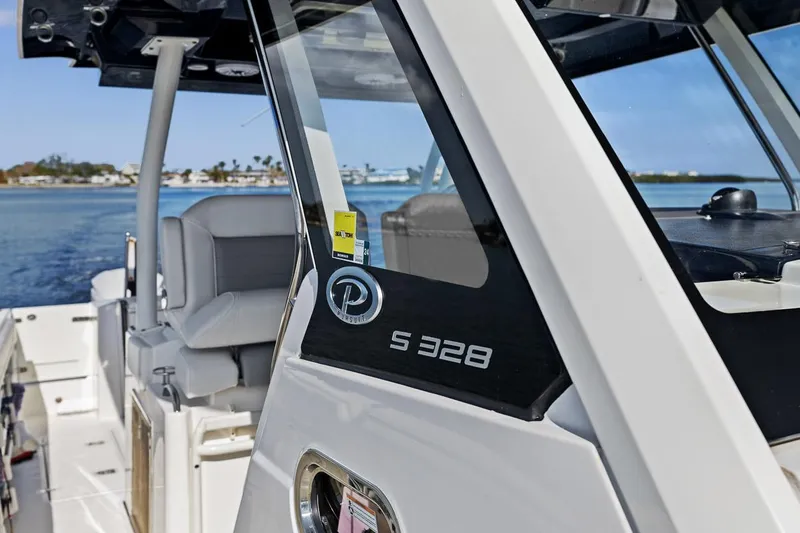  Yacht Photos Pics 2021 Pursuit S 328 Sport boat on water, showcasing sleek design and luxury features.