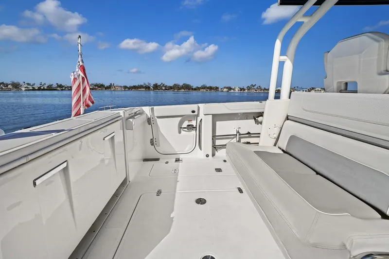  Yacht Photos Pics 2021 Pursuit S 328 Sport boat interior with seating, open deck, and ocean view.