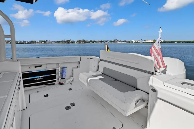  Yacht Photos Pics 2021 Pursuit S 328 Sport boat interior with seating, overlooking calm waters.