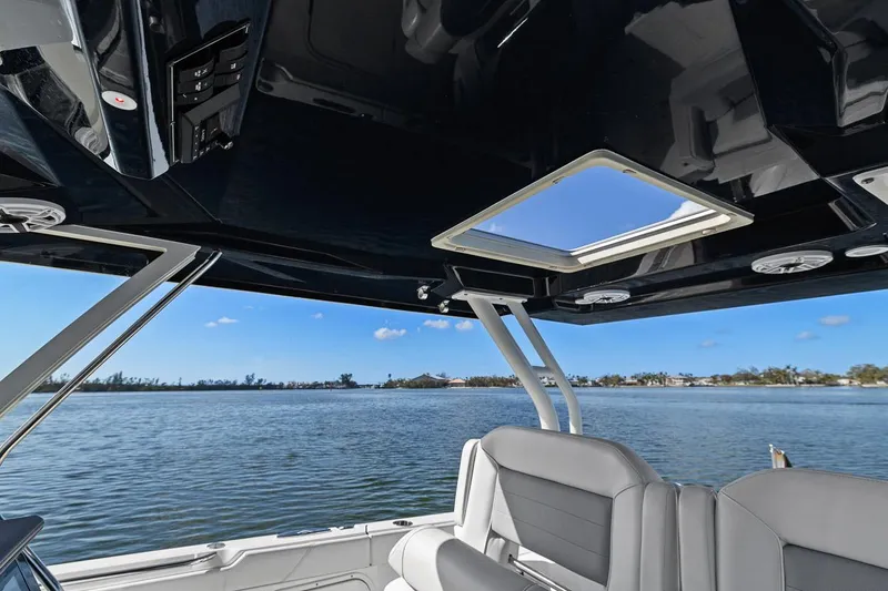  Yacht Photos Pics 2021 Pursuit S 328 Sport boat interior with water view and sleek seating.