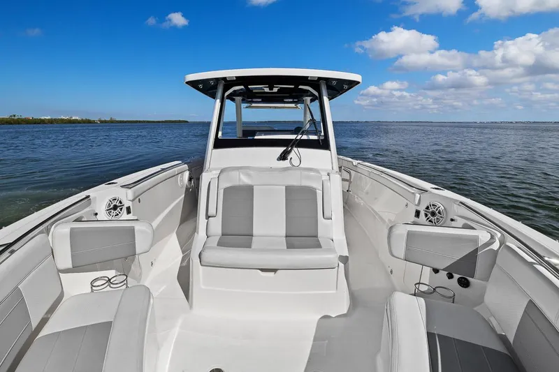  Yacht Photos Pics 2021 Pursuit S 328 Sport boat interior, featuring sleek seating and open water view.