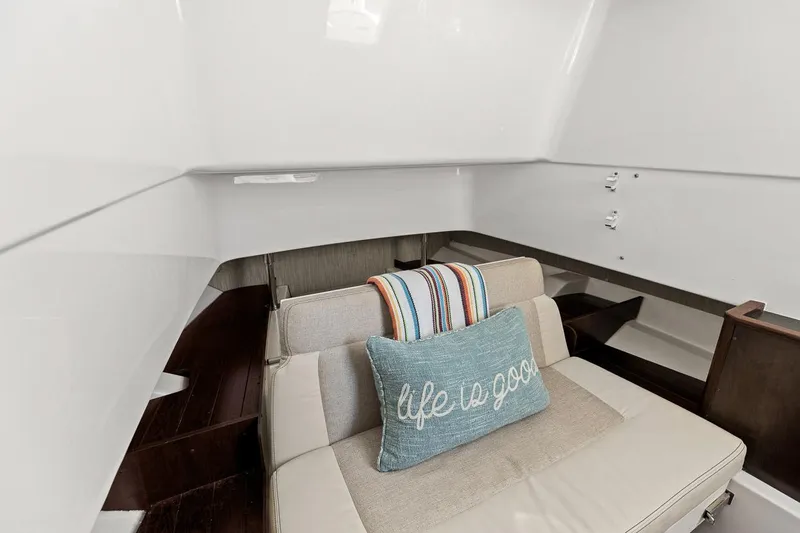  Yacht Photos Pics Interior of 2021 Pursuit S 328 Sport boat with cozy seating and decorative pillow.