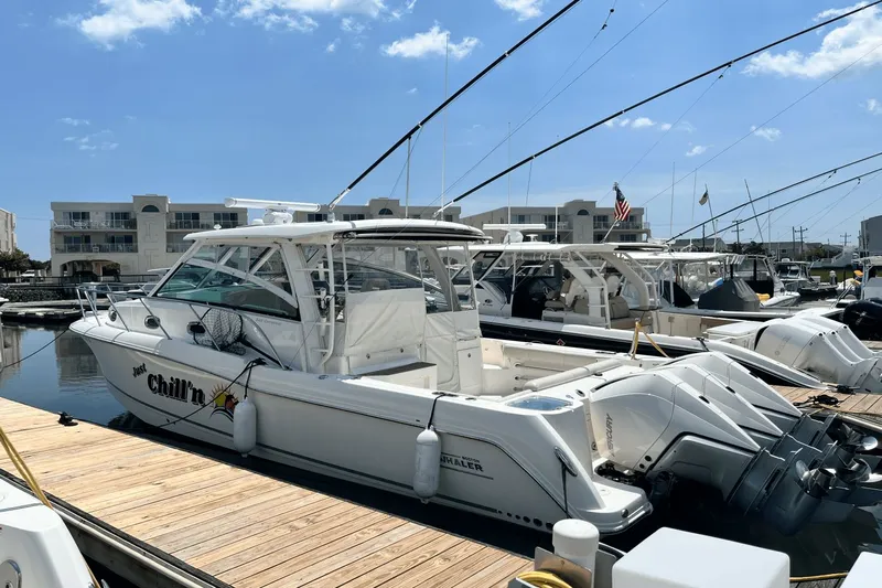  Yacht Photos Pics 2022 Boston Whaler 345 Conquest docked at marina under clear blue sky.
