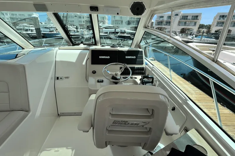  Yacht Photos Pics 2022 Boston Whaler 345 Conquest helm with Simrad electronics at marina.