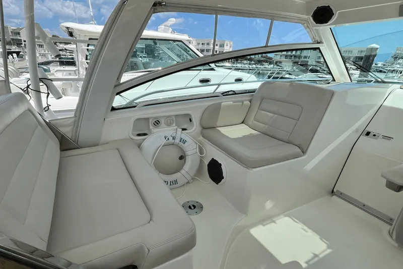  Yacht Photos Pics 2022 Boston Whaler 345 Conquest interior with cushioned seating and marina view.
