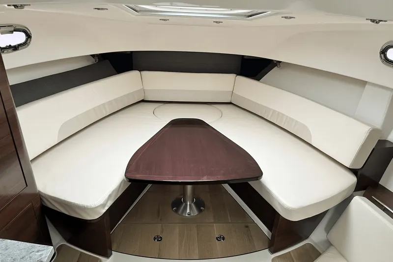  Yacht Photos Pics Luxurious interior of 2022 Boston Whaler 345 Conquest with elegant seating and wooden table.
