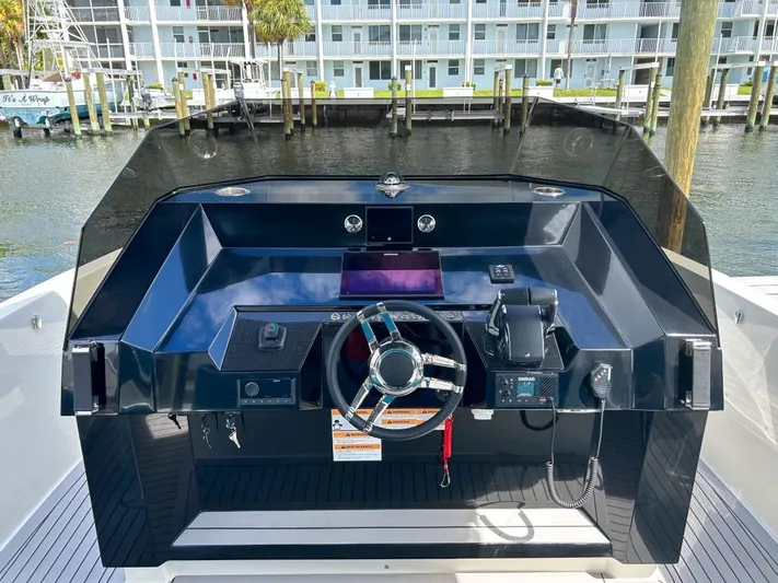  Yacht Photos Pics 2023 De Antonio Yachts D28 Open helm station with modern controls and waterfront view.