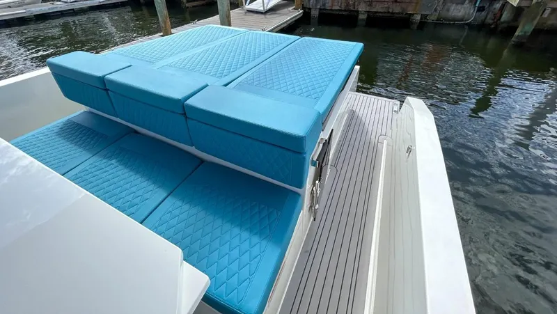  Yacht Photos Pics 2023 De Antonio Yachts D28 Open with blue cushioned seating on deck.