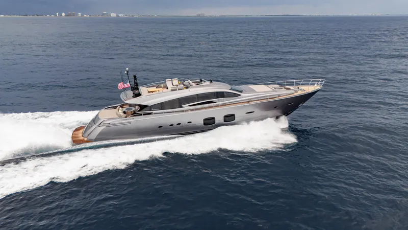  Yacht Photos Pics Luxury Pershing 108 yacht cruising on open sea, 2021 model, sleek design, American flag displayed.
