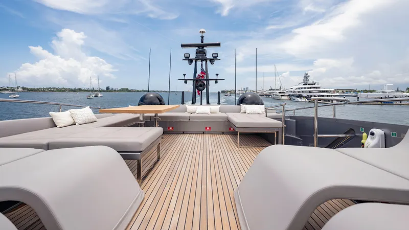  Yacht Photos Pics Luxurious 2021 Pershing 108 yacht deck with modern seating and scenic ocean view.