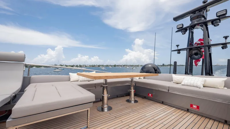  Yacht Photos Pics Luxurious 2021 Pershing 108 yacht deck with seating, table, and ocean view.