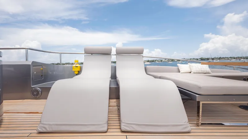  Yacht Photos Pics Luxury sun loungers on Pershing 108 yacht deck, 2021 model, with ocean view.