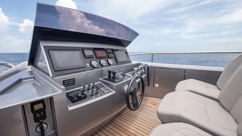  Yacht Photos Pics Helm of 2021 Pershing 108 yacht with modern controls and ocean view.