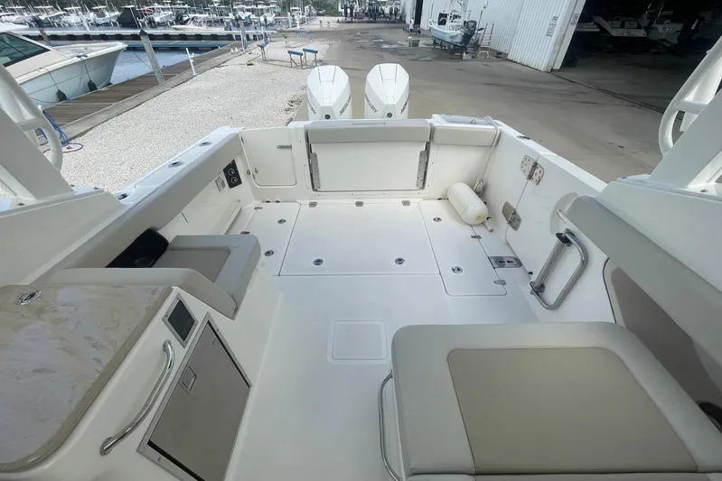 Only 88 Hours! Yacht Photos Pics 2023 Boston Whaler 280 Vantage boat interior with seating and storage compartments.