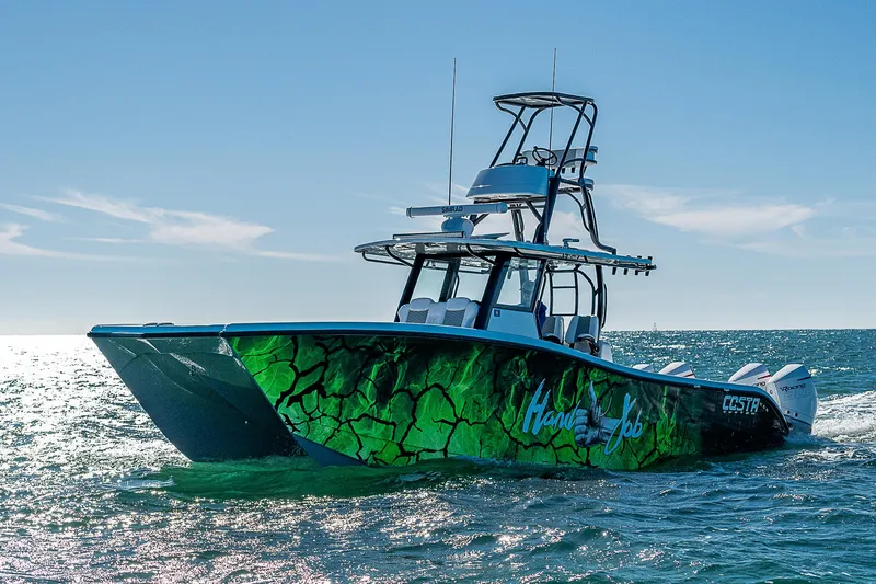  Yacht Photos Pics 2024 Costa Custom Boats 34 on water, vibrant green design, sunny day.