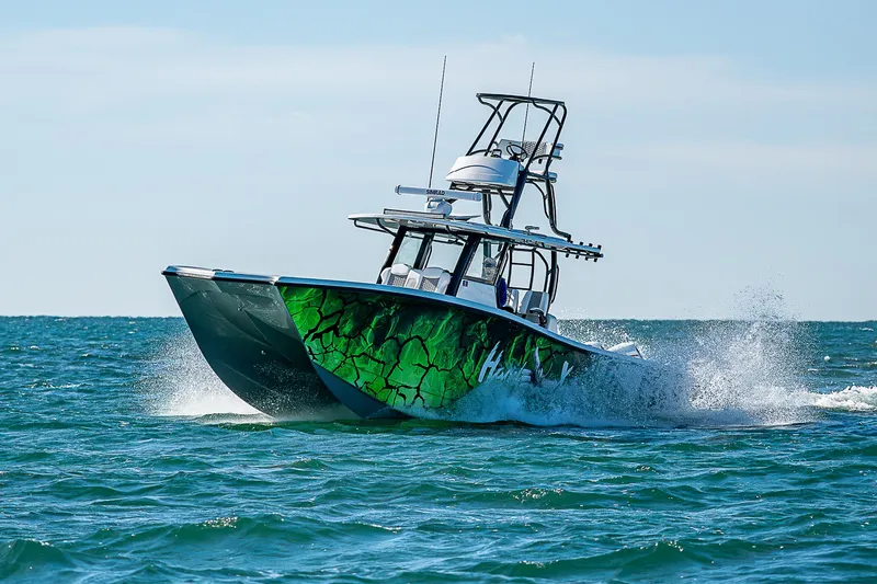  Yacht Photos Pics 2024 Costa Custom Boats 34 cruising on ocean with vibrant green hull design.