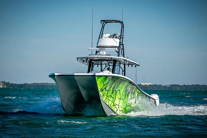  Yacht Photos Pics 2024 Costa Custom Boats 34 cruising on open water with vibrant green hull design.