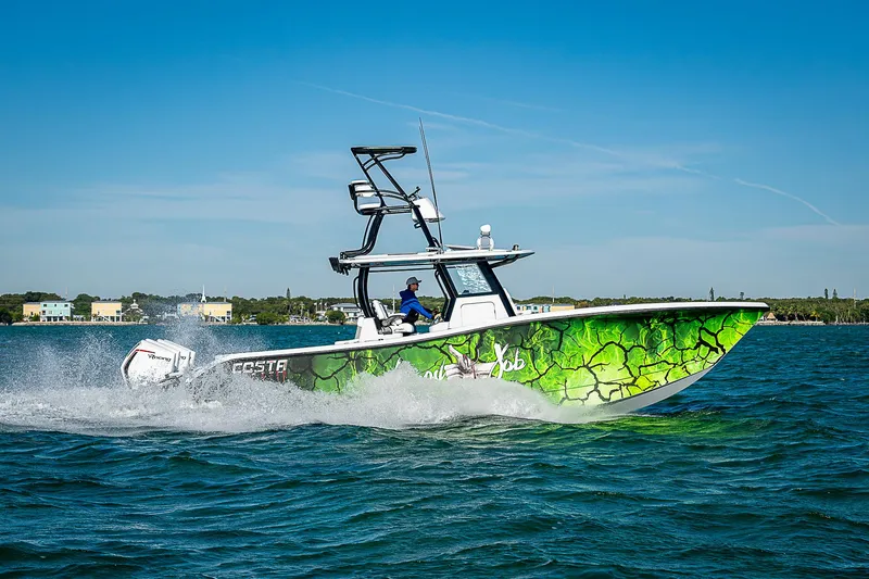  Yacht Photos Pics 2024 Costa Custom Boats 34 cruising on water with vibrant green hull design.