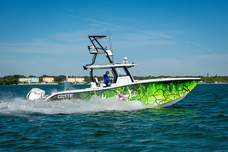  Yacht Photos Pics 2024 Costa Custom Boats 34 cruising on water with vibrant green hull design.