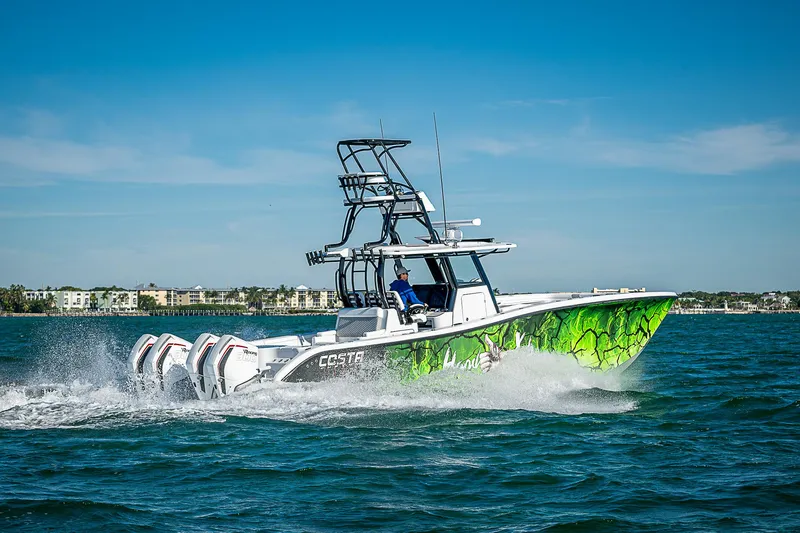  Yacht Photos Pics 2024 Costa Custom Boats 34 cruising on open water with vibrant green hull design.