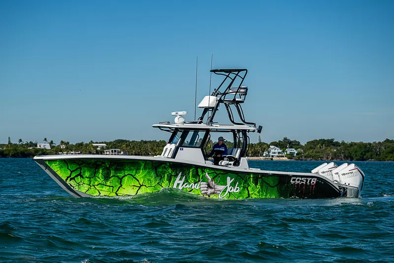  Yacht Photos Pics 2024 Costa Custom Boats 34 cruising on water with vibrant green hull design.