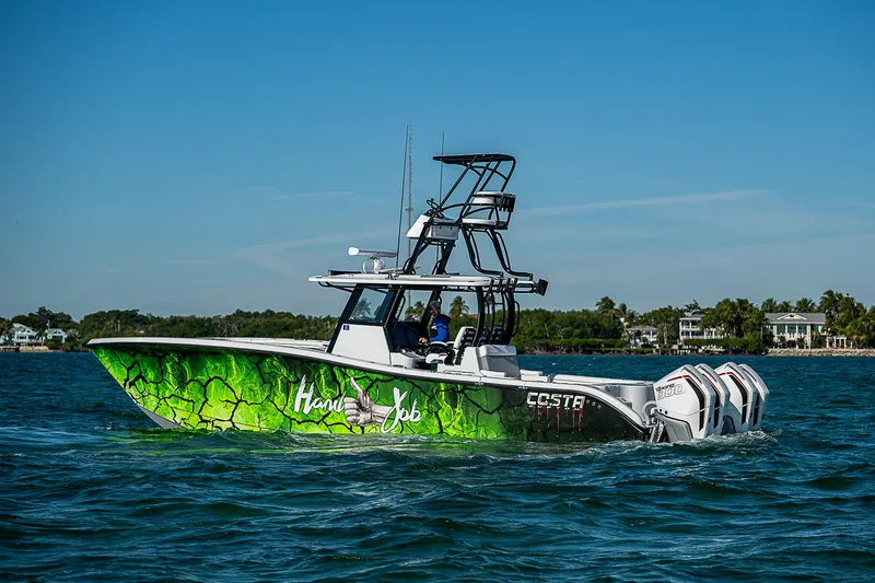  Yacht Photos Pics 2024 Costa Custom Boats 34 on water, vibrant green design, clear blue sky.