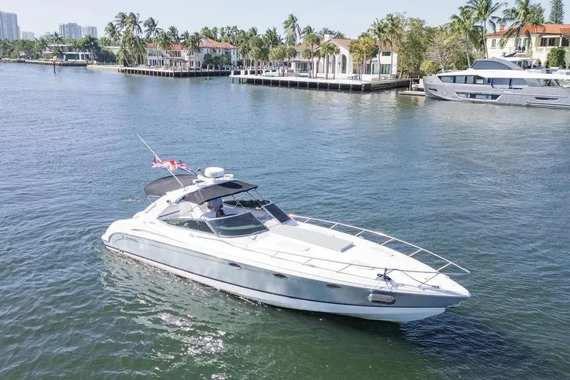 Gentleman's Legacy Yacht Photos Pics 2004 Formula 400 Super Sport Crossover yacht cruising on a sunny waterfront.