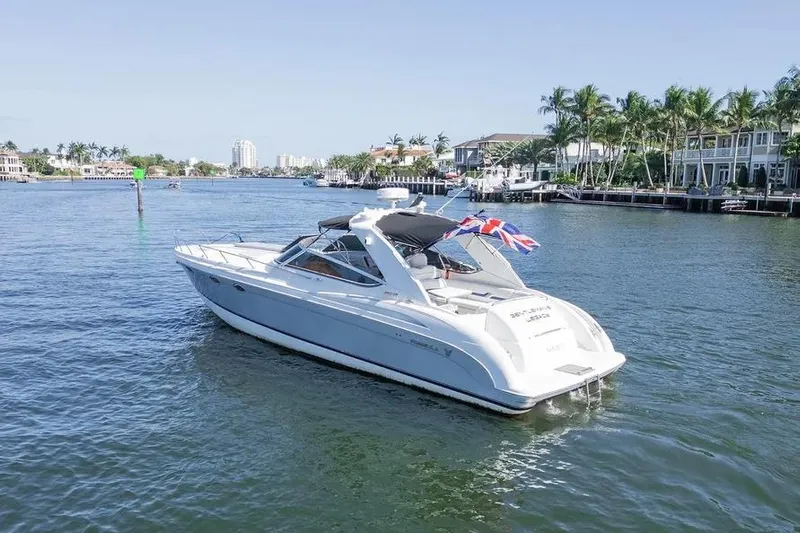 Gentleman's Legacy Yacht Photos Pics 2004 Formula 400 Super Sport Crossover yacht cruising on a sunny waterfront.