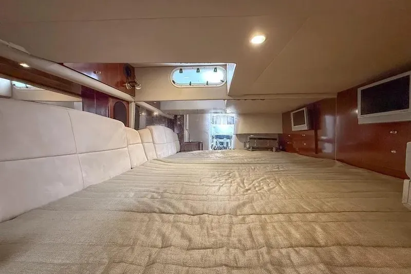 Gentleman's Legacy Yacht Photos Pics Interior cabin of 2004 Formula 400 Super Sport Crossover with bed and porthole window.