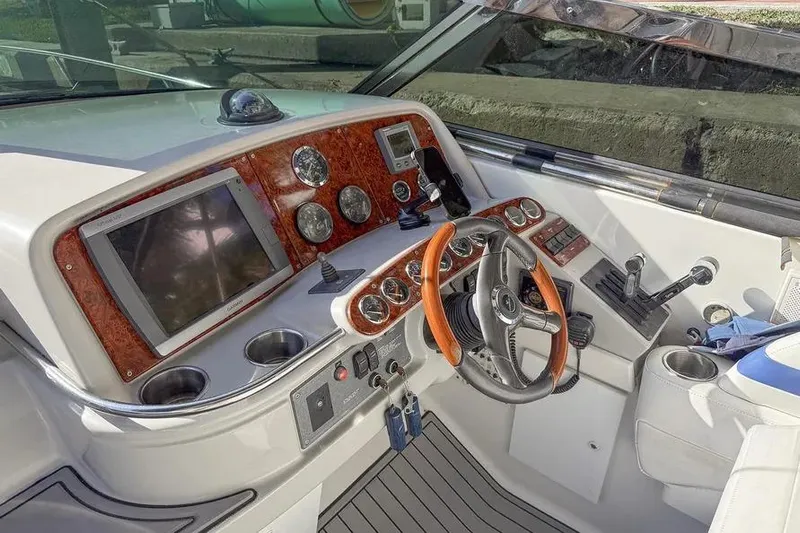 Gentleman's Legacy Yacht Photos Pics Cockpit of 2004 Formula 400 Super Sport Crossover with wood accents and modern controls.