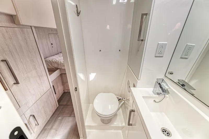 Aquarius Yacht Photos Pics Compact bathroom in 2016 Leopard 58 yacht with modern fixtures and adjacent sleeping area.