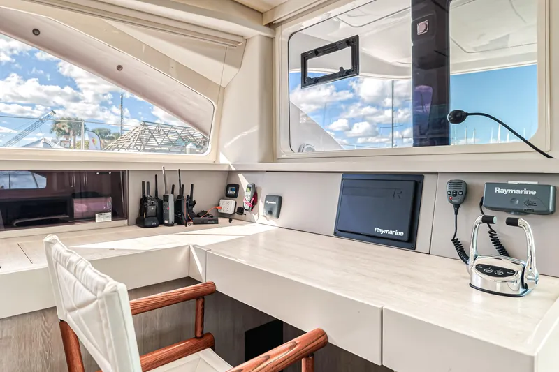 Aquarius Yacht Photos Pics Modern yacht interior with navigation equipment, featuring a desk and chair, aboard a 2016 Leopard 58.
