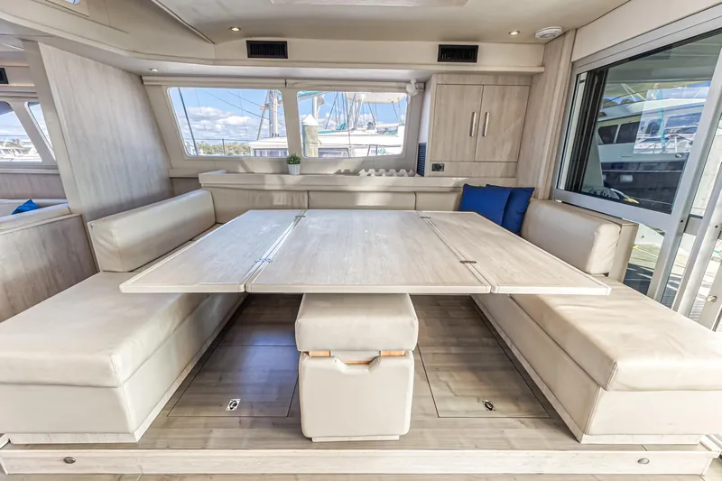 Aquarius Yacht Photos Pics Luxurious interior of 2016 Leopard 58 yacht with spacious dining area and modern furnishings.